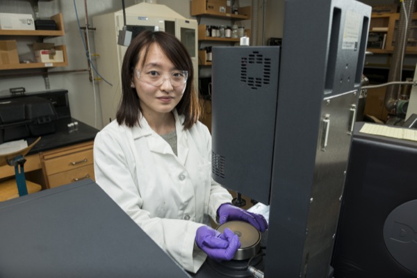 woman in lab coat with lab equipment