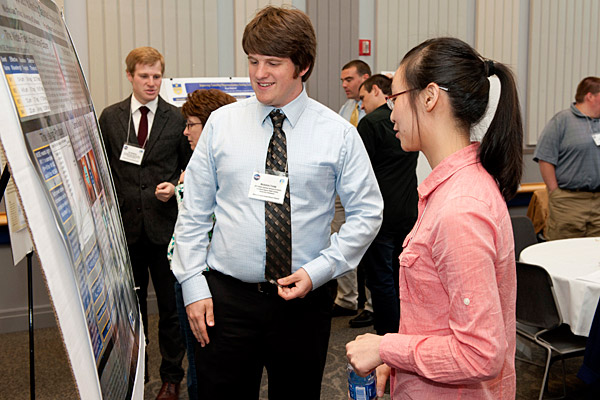 two students looking at poster