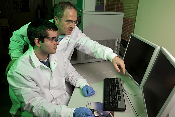 professor and student looking at a computer