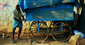 Man with blue cart